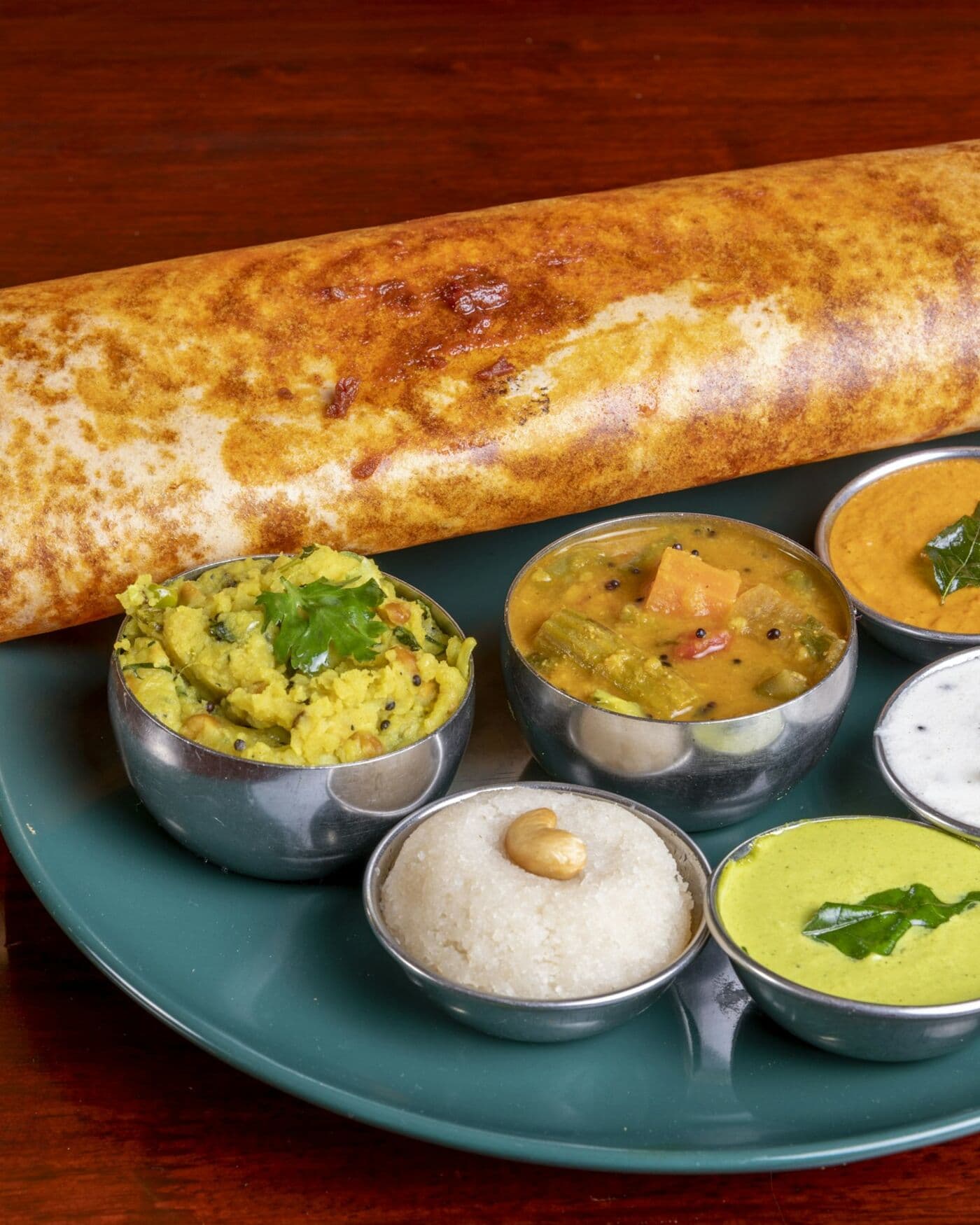 A crisp dosa with potato masala, sambar and chutneys